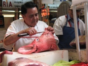 Butcher dressing a huge Pig's Head